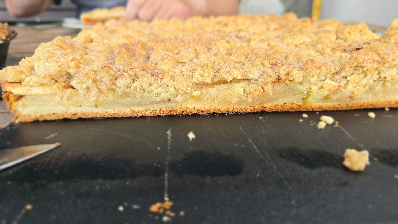 Crumble cake cut open, the base fully baked